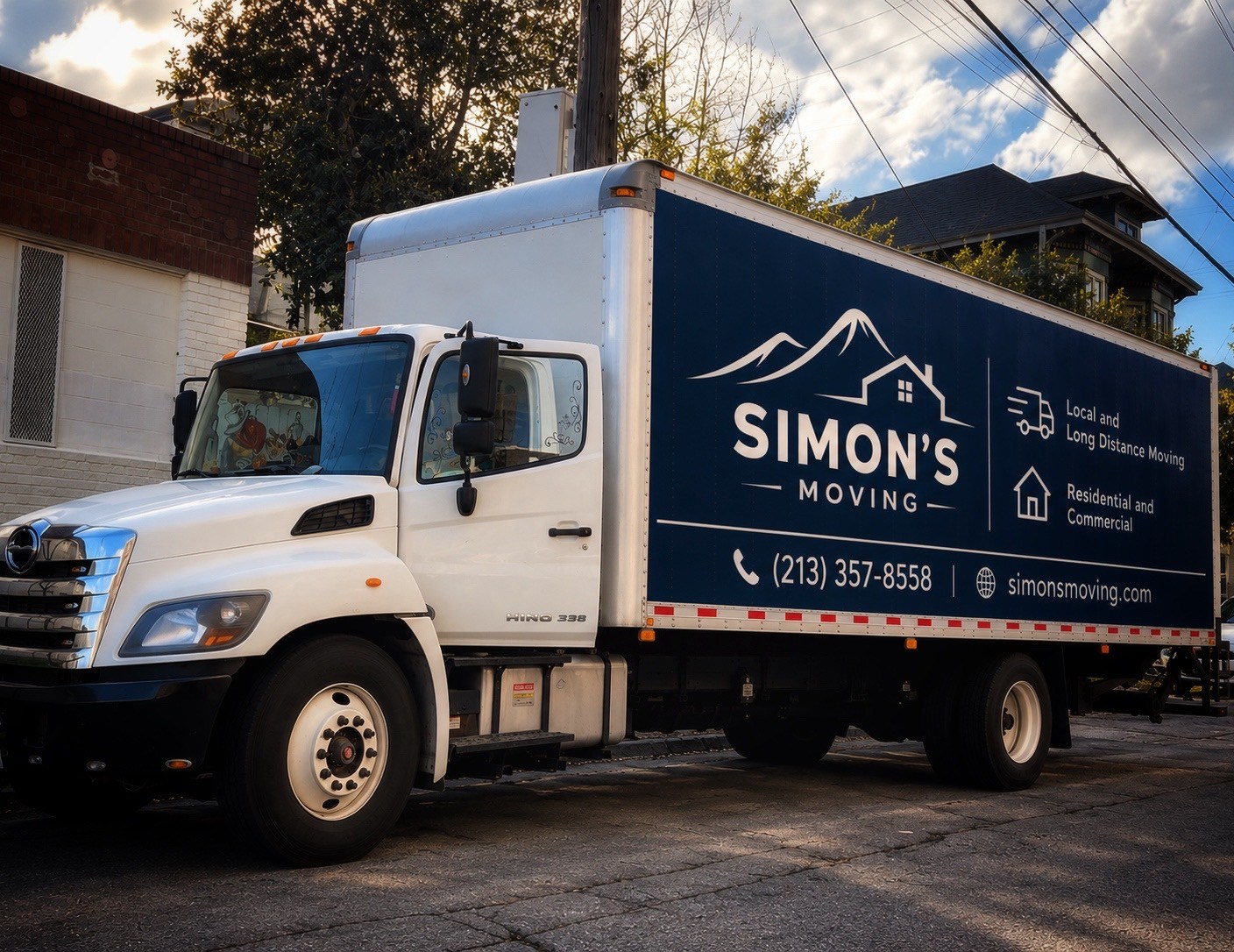 Simon's Moving truck with navy branding parked outside on a moving day