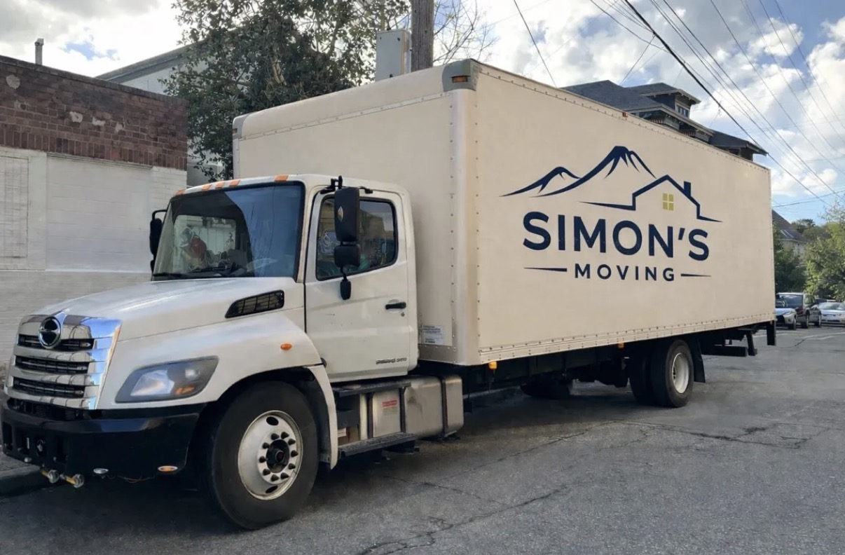 Simon's Moving branded truck parked at a completed job