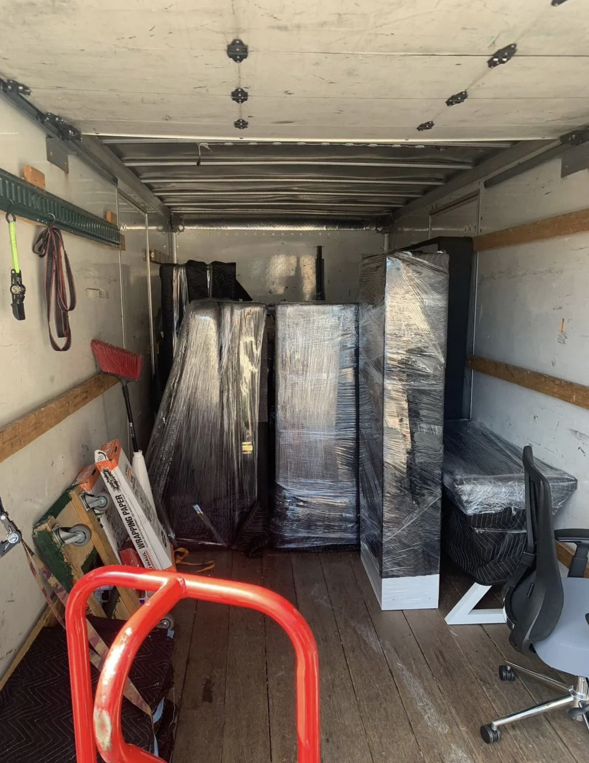 Office furniture protected and loaded for moving
